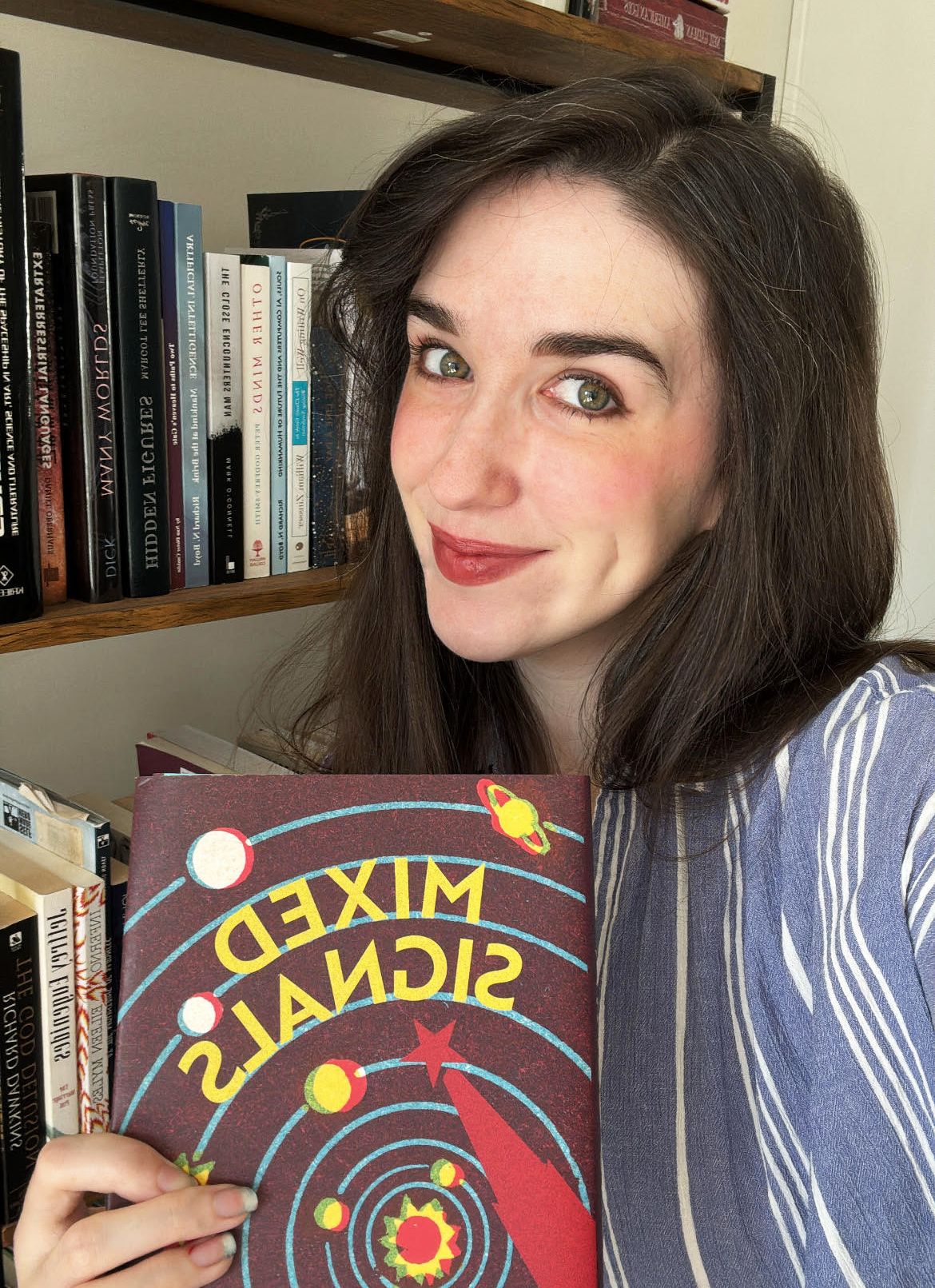 Rebecca Charbonneau with her book Mixed Signals