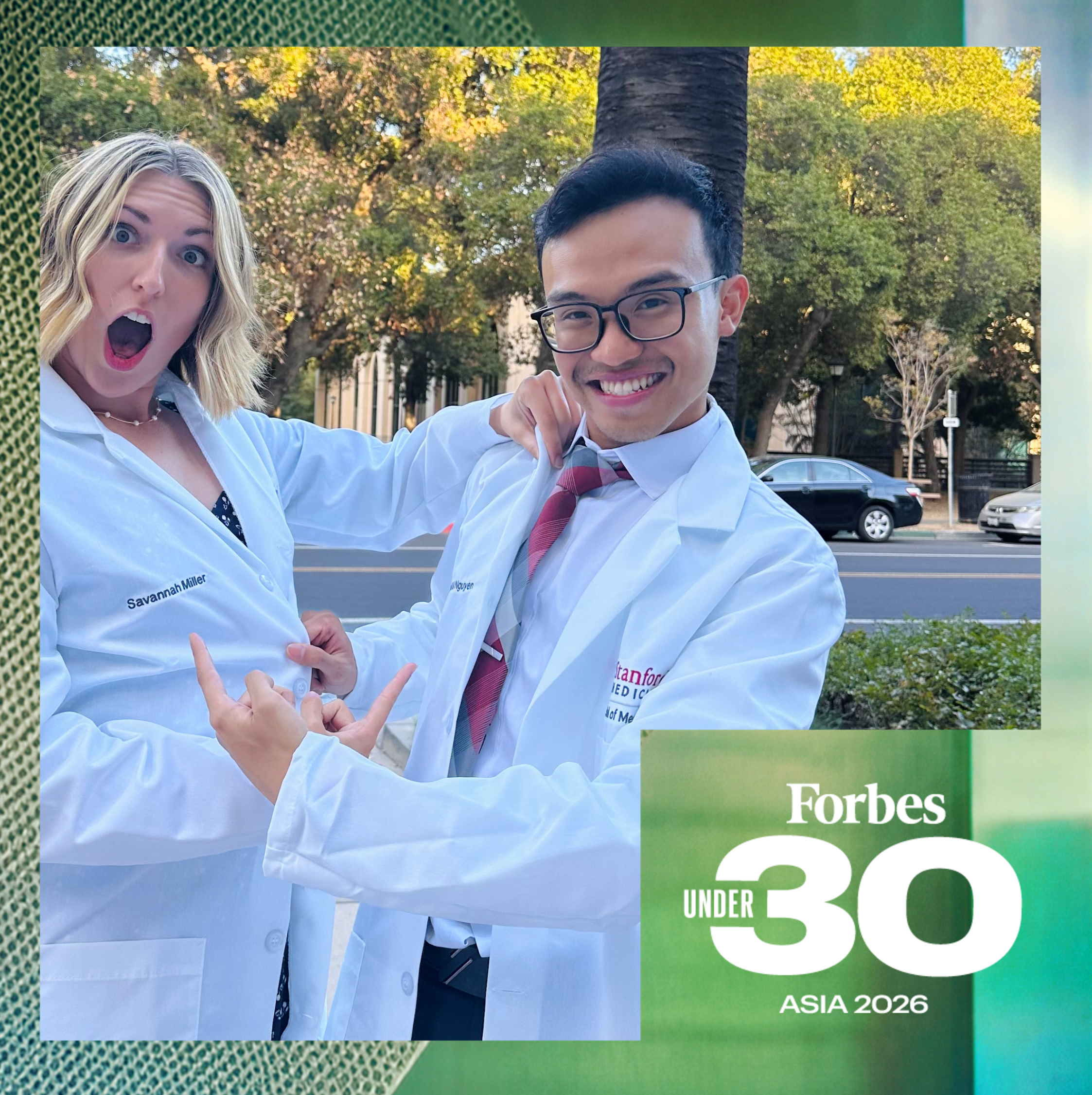 Male and female scientists in lab coats with Forbes 30 Under 30 banner
