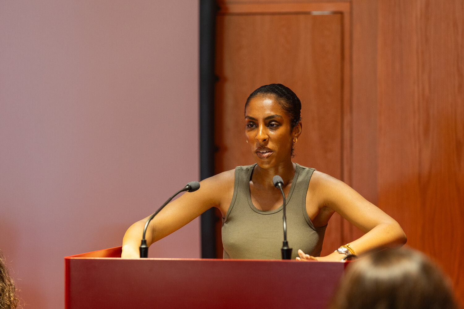 Woman at lectern with two microphones
