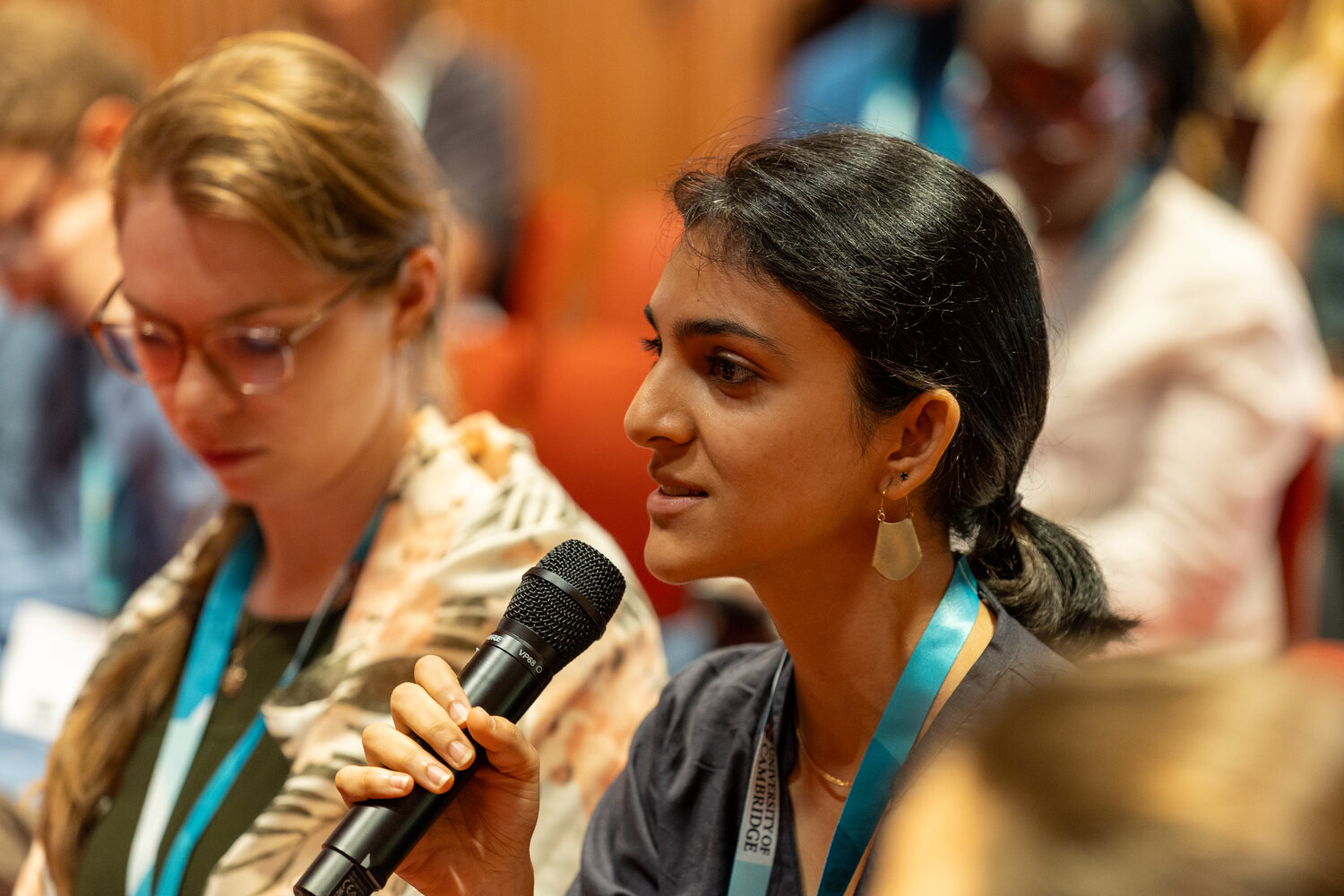 Woman with microphone asking a question