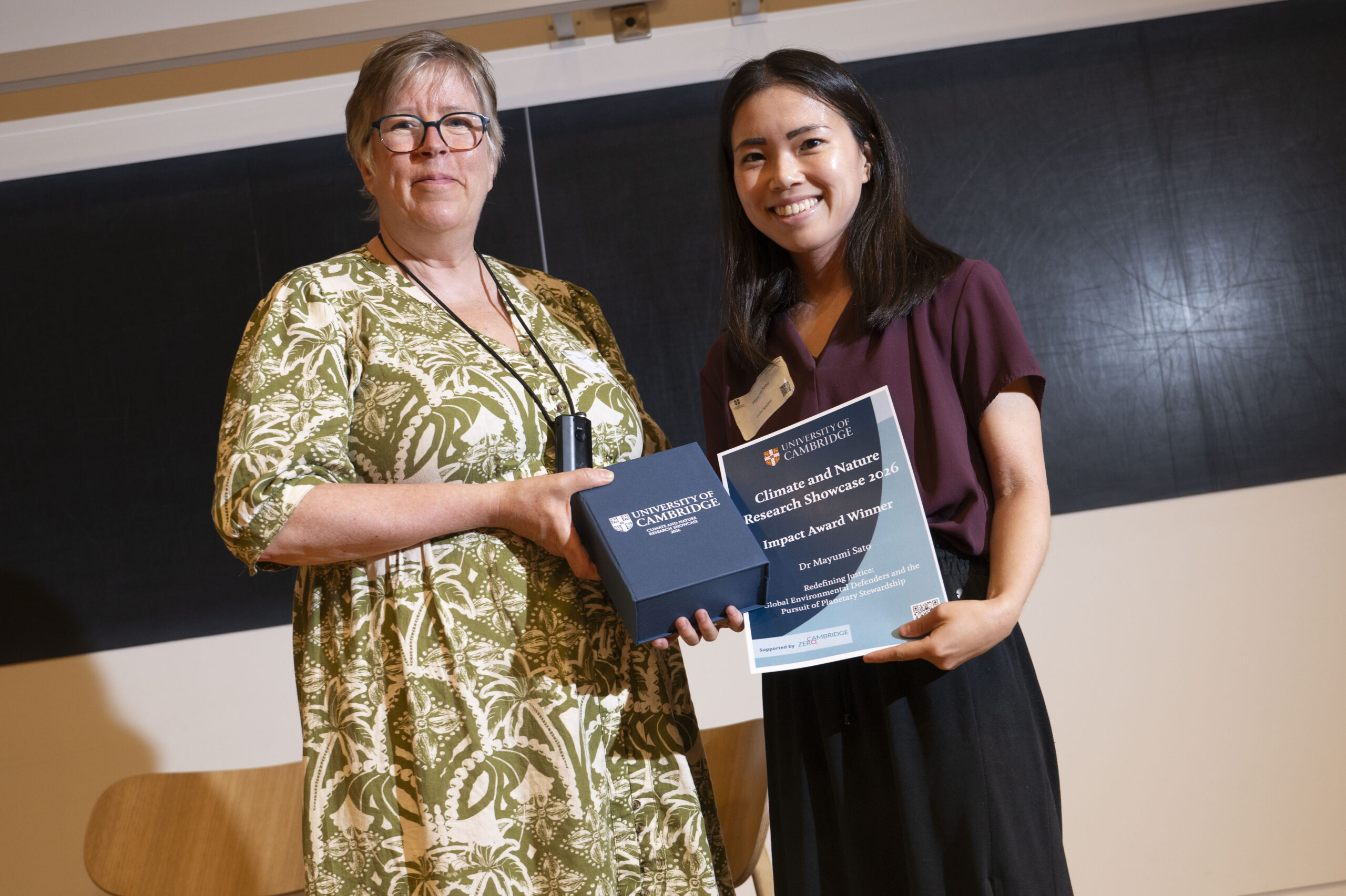 Woman hands award to student