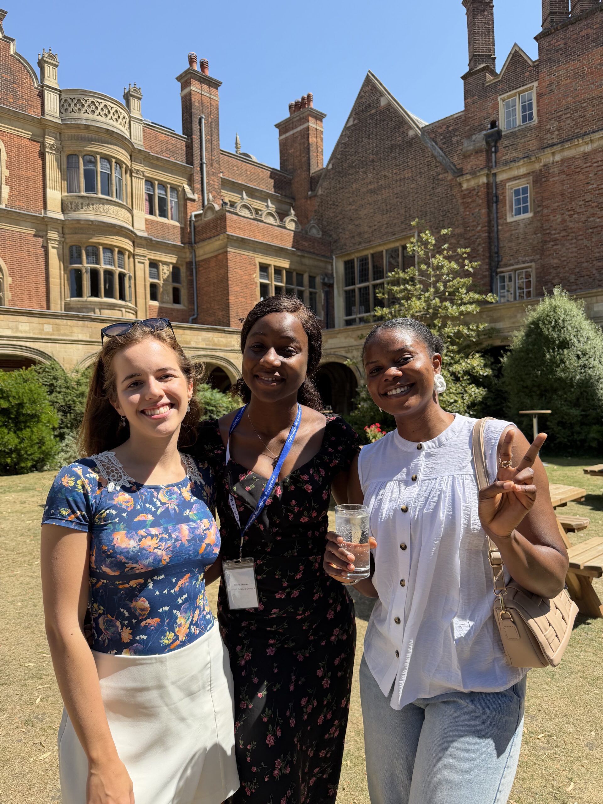 Group of three young women outside old building