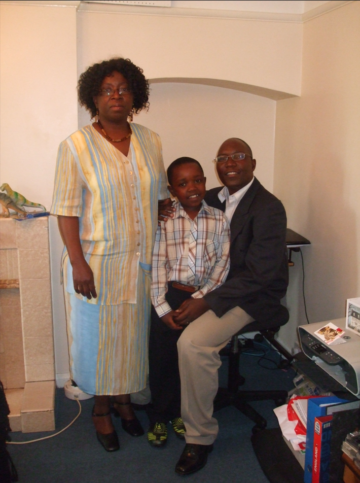 Man and woman with child sitting on man's knee