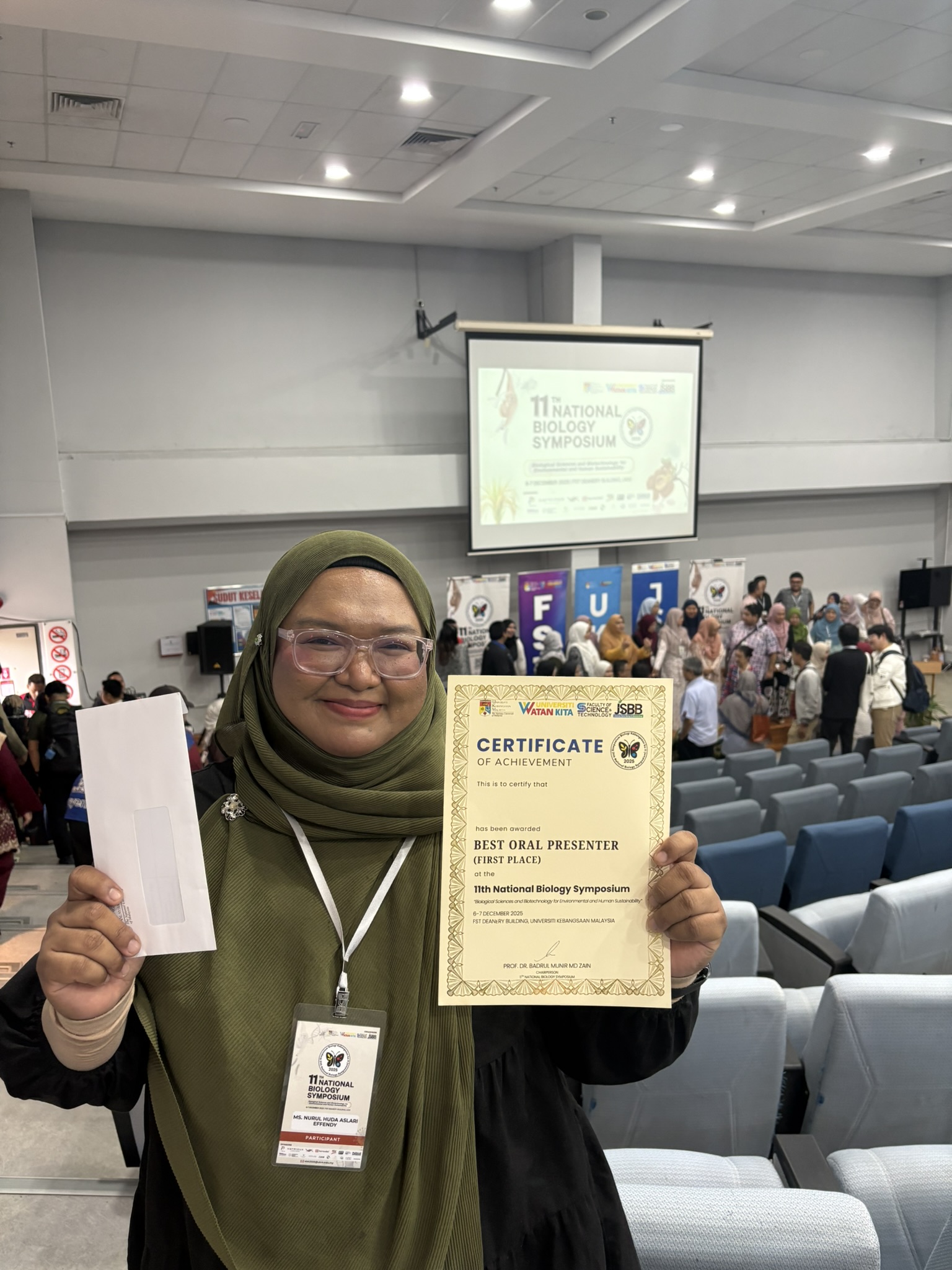 Woman holding up certificate in classroom