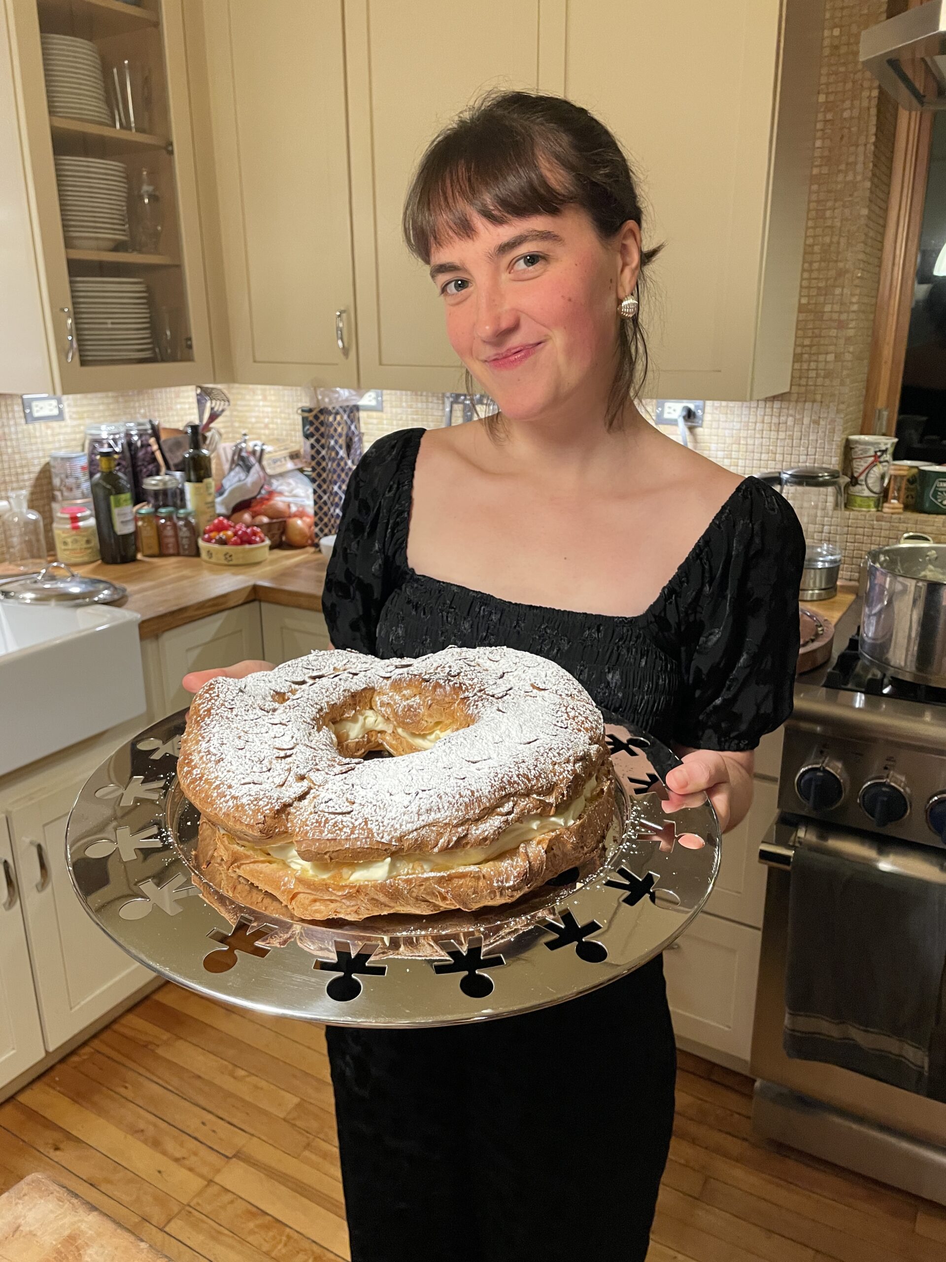 Woman holding cake in kitchen